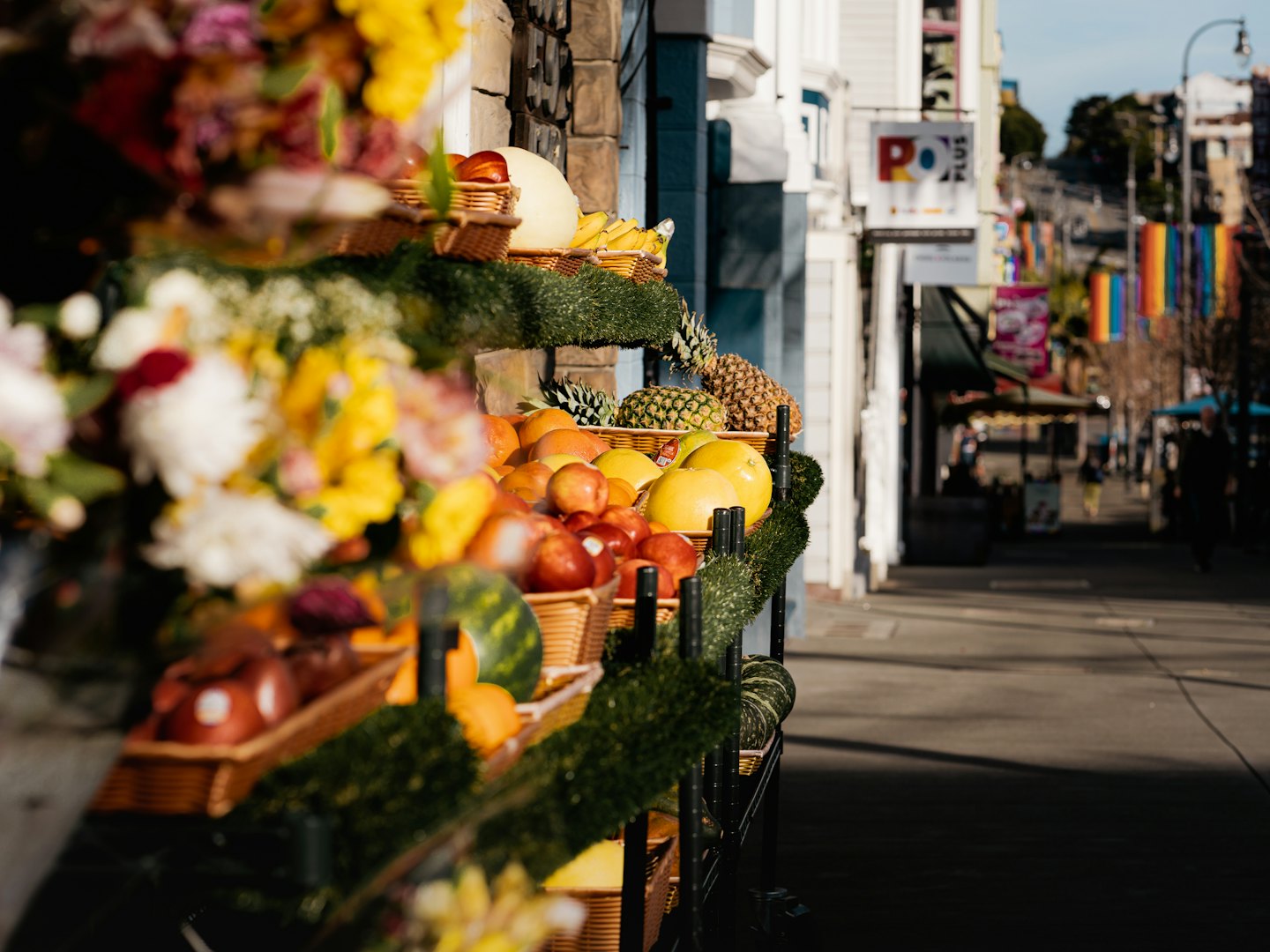 Fresh fruit for sale in woven baskets at an outdoor market.